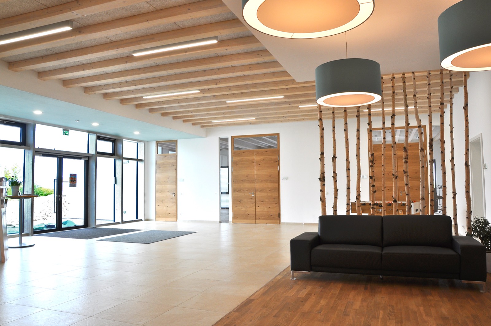 FeG Coburg – helles Foyer mit Holzdecke und Sitzbereich